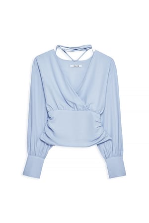 Light Blue Overlappende blouse met strik in de nek