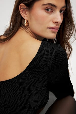 Black Top estructurado con corte sesgado