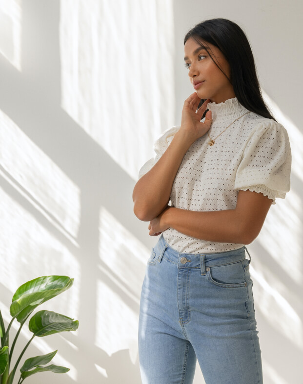 Young woman looking thoughtfully out through a window