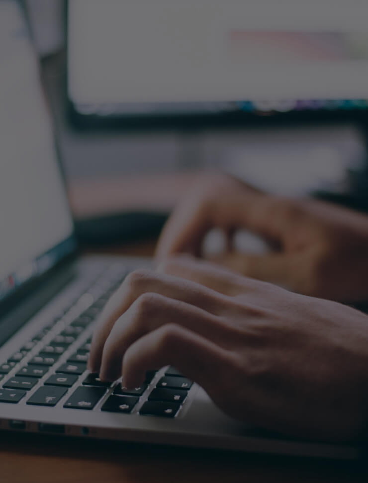 Fingers typing on laptop