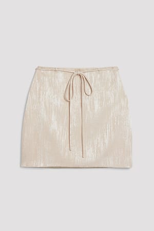 Champagne Glanzende minirok met strikdetail