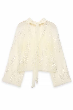 Offwhite Plisserad topp i mesh med paljetter