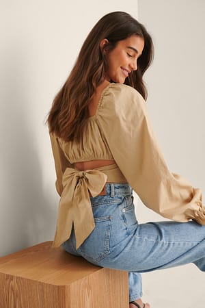 Beige Organische katoenen blouse met lange mouwen en gestrikte achterkant