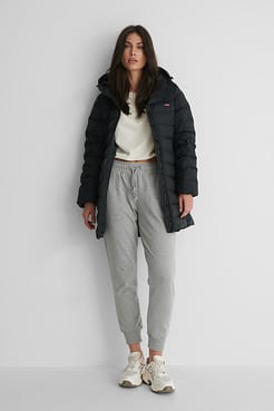 Core Down Mid Puffer Parka with Sweatpants and Sneakers.